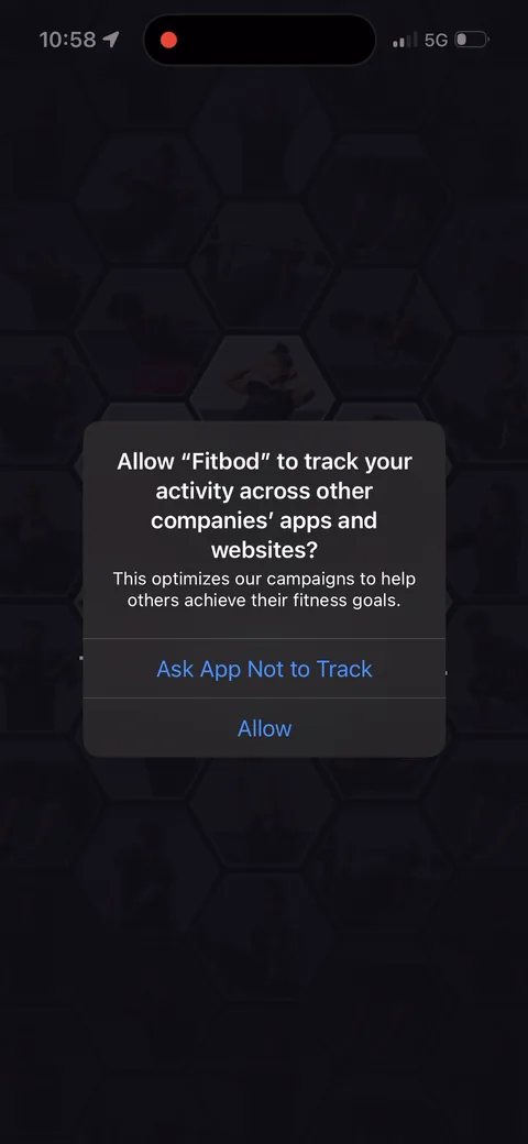 Fitbod onboarding screen 94: ATT prompt right after signup, with custom copy: 'This optimizes our campaigns to help others achieve their…