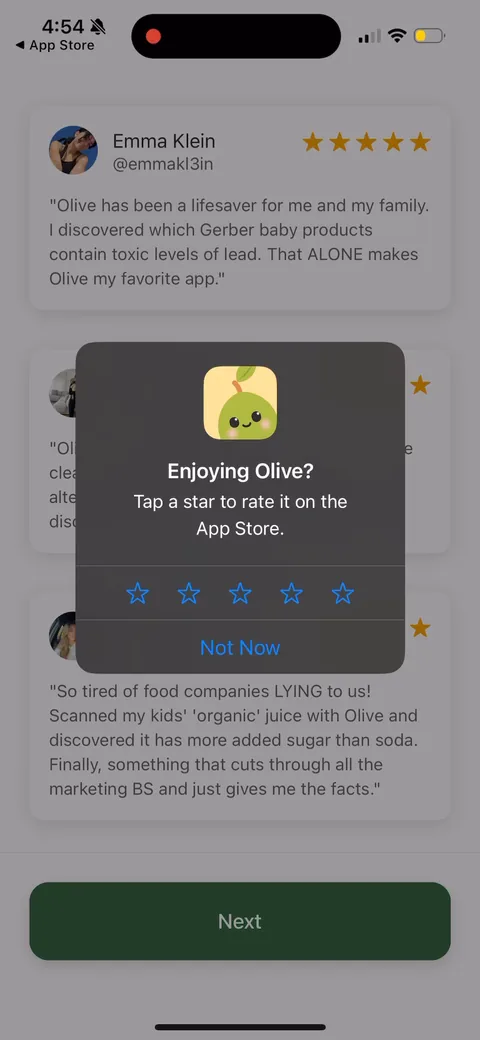 Olive onboarding screen 22: A native star-rating prompt dropped in front of the paywall, stacked on top of glowing testimonials