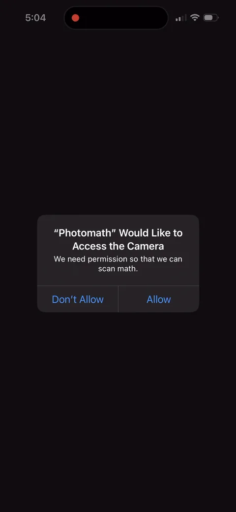 Photomath onboarding screen 4: The permission prompt uses a custom reason, 'We need permission so that we can scan math', instead of Apple's…